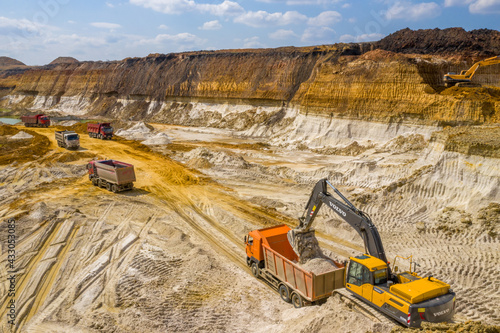 Quarry, mining and construction, excavators and trucks, view from above photo