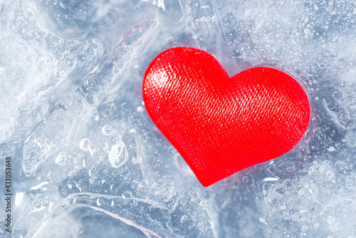 Red heart on pieces of melting ice. Start of new love  relationships  to fall in love