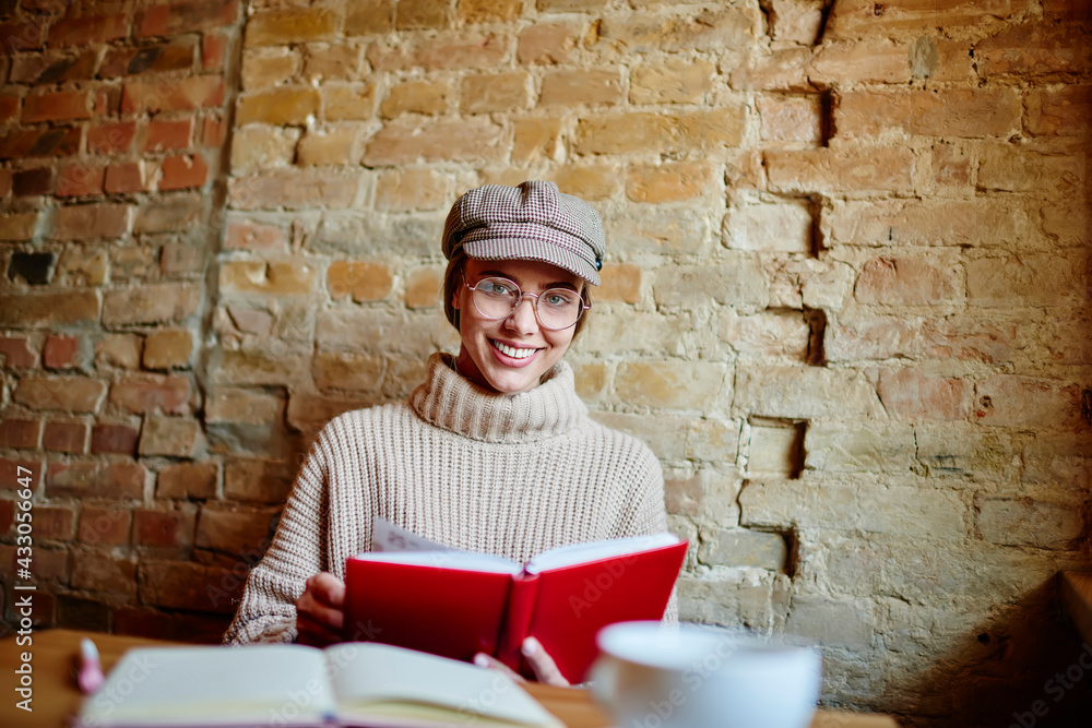 Smiling woman reading notes during work Smiling woman reading notes during work