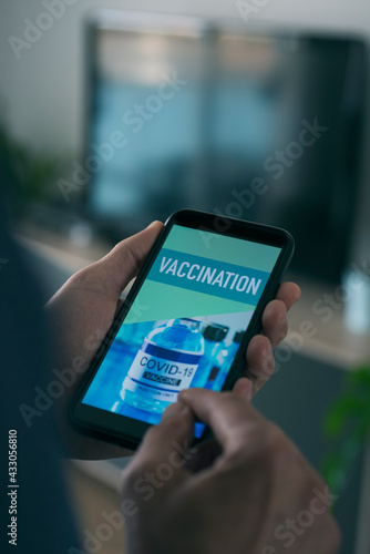 man and text vaccination in his smartphone