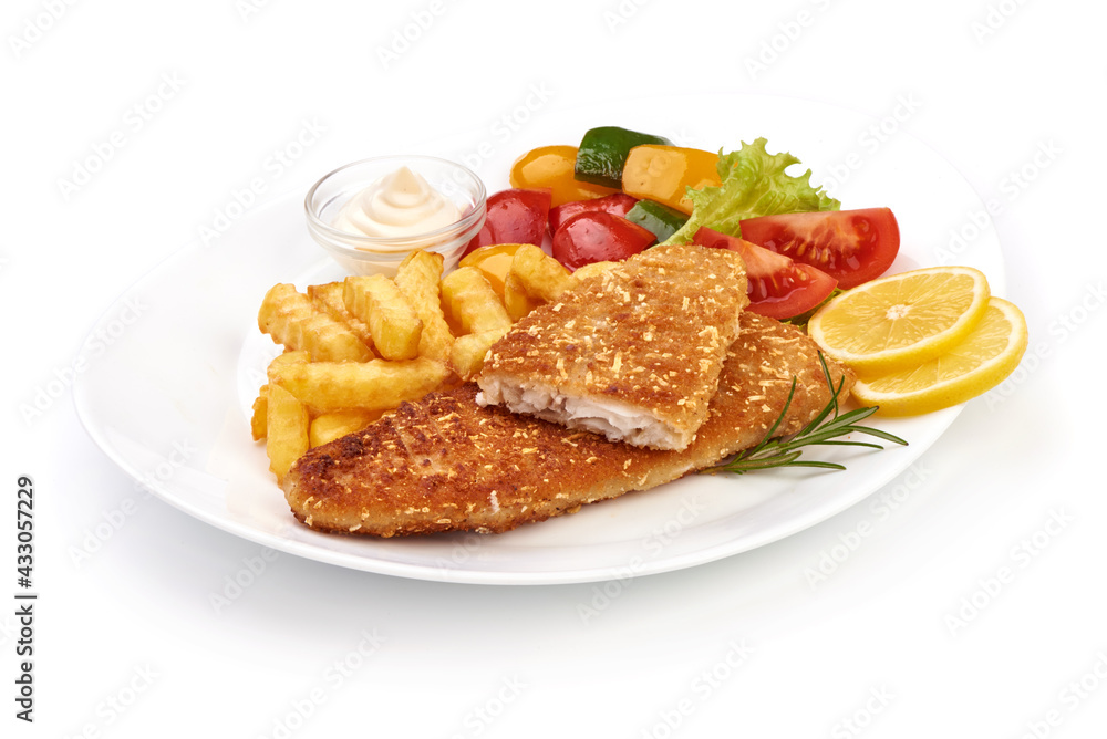 Fried Fish cutlet with French fries and vegetables, isolated on white background. High resolution image Fried Fish cutlet with French fries and vegetables, isolated on white background. High resolution image