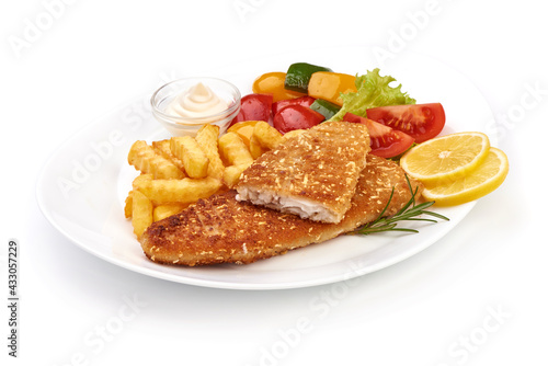 Fried Fish cutlet with French fries and vegetables, isolated on white background. High resolution image