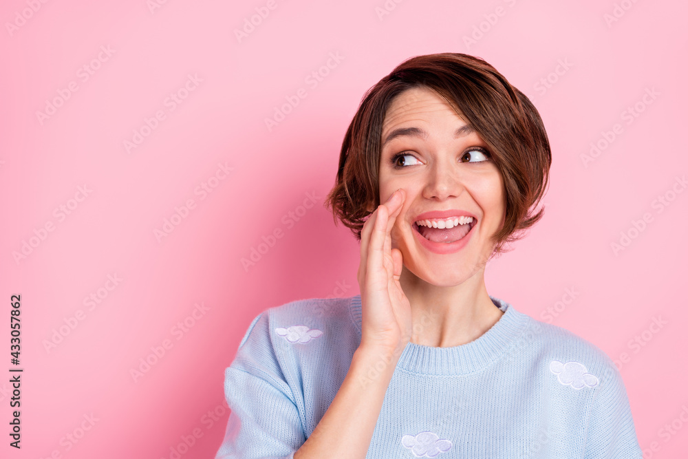 Photo of cheerful person arm near open mouth look interested empty space tell isolated on pink color background Photo of cheerful person arm near open mouth look interested empty space tell isolated on pink color background