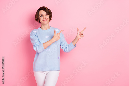 Photo of pretty positive lady look direct fingers empty space promotion isolated on pink color background © deagreez