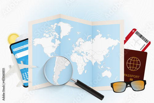 Travel destination Argentina, tourism mockup with travel equipment and world map with magnifying glass on a Argentina.