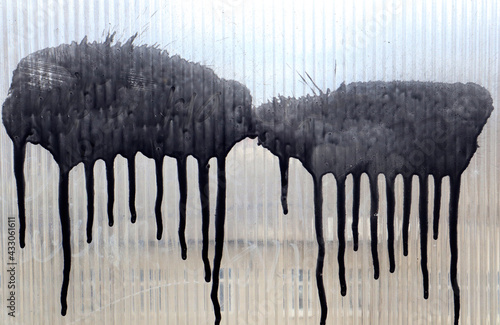 Obraz na plátně Black paint spread in rivulets on a light plastic background, like two sheep, cl