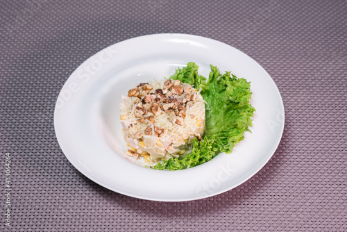 Freshness prepared salad with chicken breast, pineapple and walnuts on the table in a restaurant