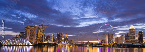 Wide panorama of Singapore cityscape at dusk.
