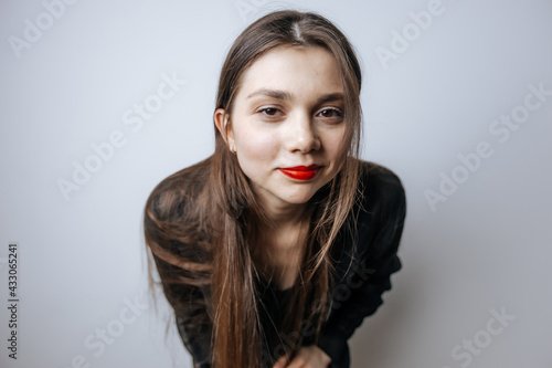 Portrait of a beautiful girl with red lips  big eyes and dark long hair
