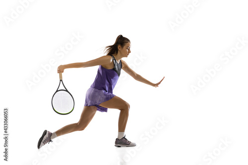 Young caucasian woman playing tennis isolated on white studio background in action and motion, sport concept © master1305