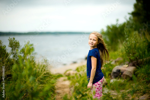 Girl playing by the Water, Playing on the shore, Playing in the fresh air, Selective focus