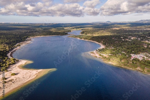 Aerial view of Lagoa de Albufeira, a natural lake meeting the Atlantic Ocean in south Portuguese coastline, Sesimbra Municipality, Setubal, Portugal.