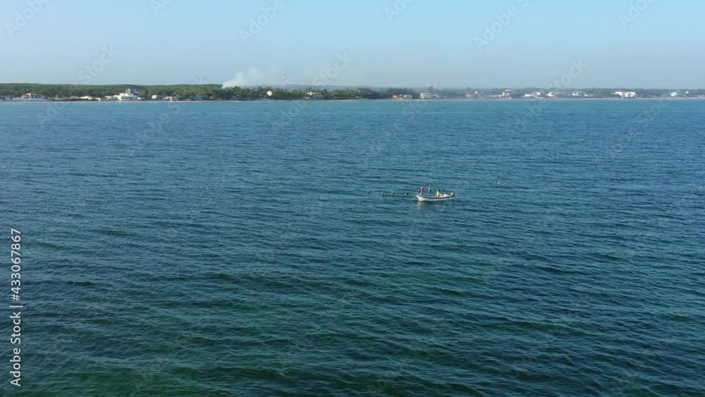 Low aerial orbit of fishing boat at sunrise off the coast. Low aerial orbit of fishing boat at sunrise off the coast.