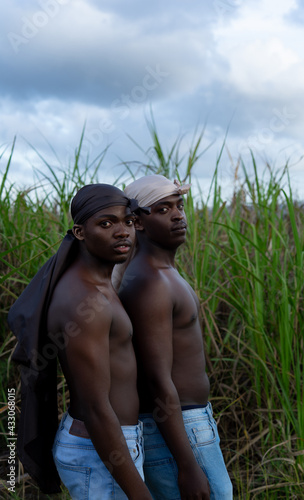 Young men in do-rags in cane field