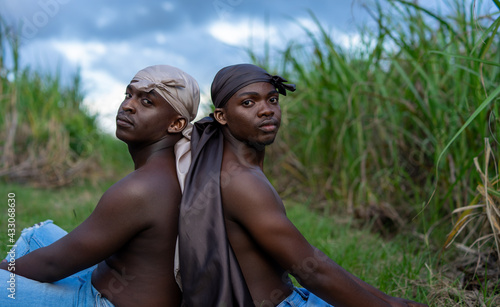 Young men in do-rags in cane field