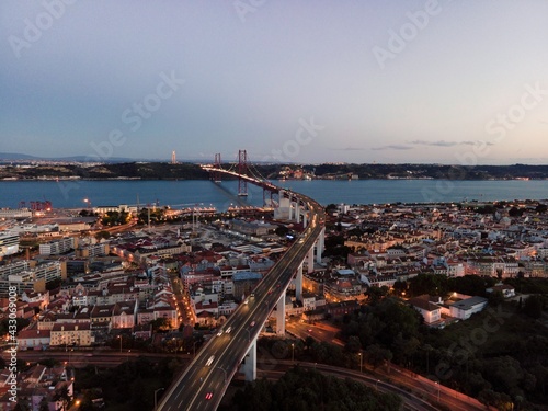 Obraz na płótnie Aerial view of April 25th bridge with Christ the King statue (Cristo Rei) in background at sunset, view of Lisbon skyline at night, Alcântara, Lisbon, Portugal. w salonie