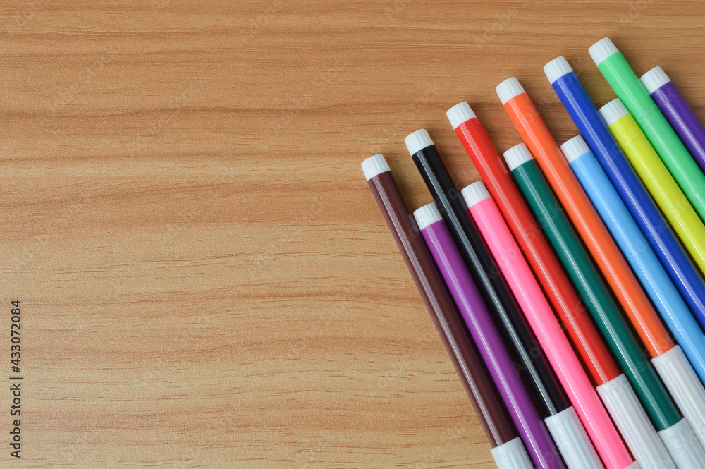 Top view of pen colors on wooden table with copy space Top view of pen colors on wooden table with copy space