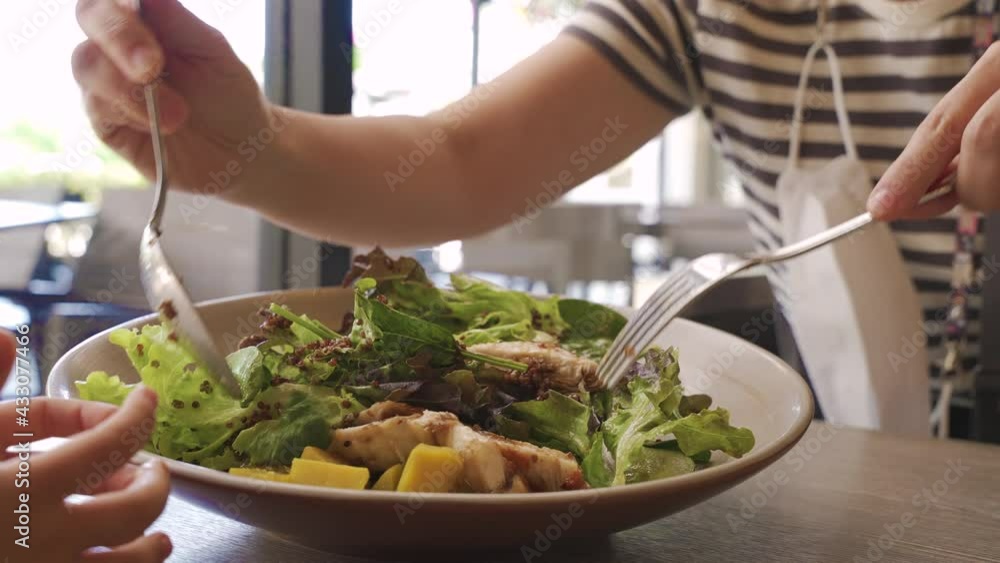 Close up shot of people who love healthy food doing mix chicken salad dish Close up shot of people who love healthy food doing mix chicken salad dish