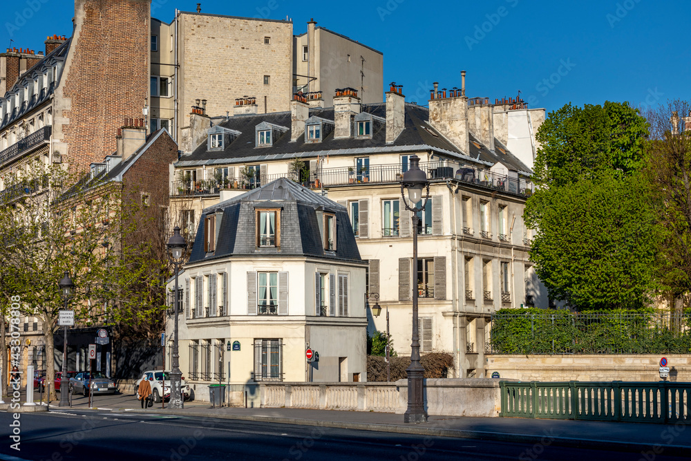Paris, France - April 13, 2021: View of ile saint-louis and quai Henri IV, typical facades and quays in Paris
