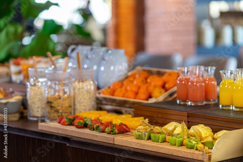 Breakfast buffet served with orange juice, croissants cereal and strawberry fruits