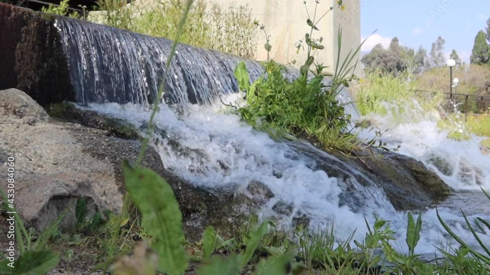 Water Diversion Culvert with Cascading Water as a Lake Receives Water
