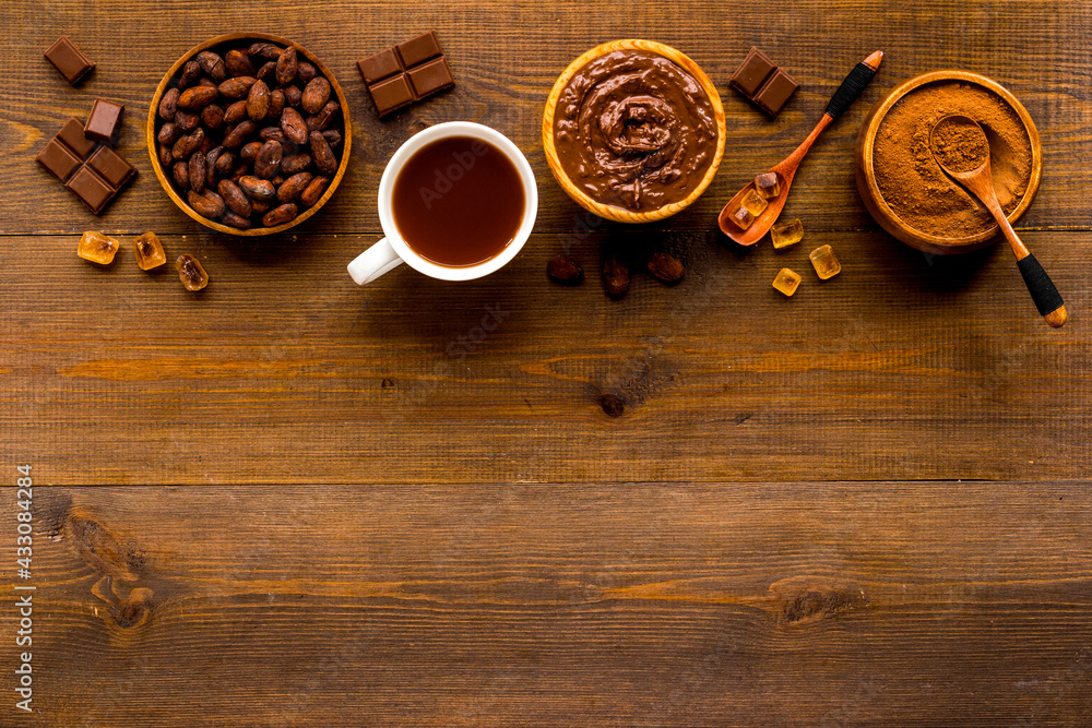 Hot chocolate in cup with cocoa and coffee beans, top view Hot chocolate in cup with cocoa and coffee beans, top view