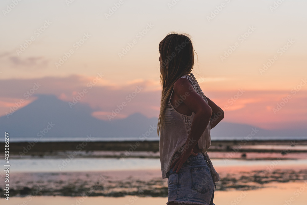Young blonde girl on Gili Trawangan beach in Lombik, Indonesia at sunset time Young blonde girl on Gili Trawangan beach in Lombik, Indonesia at sunset time