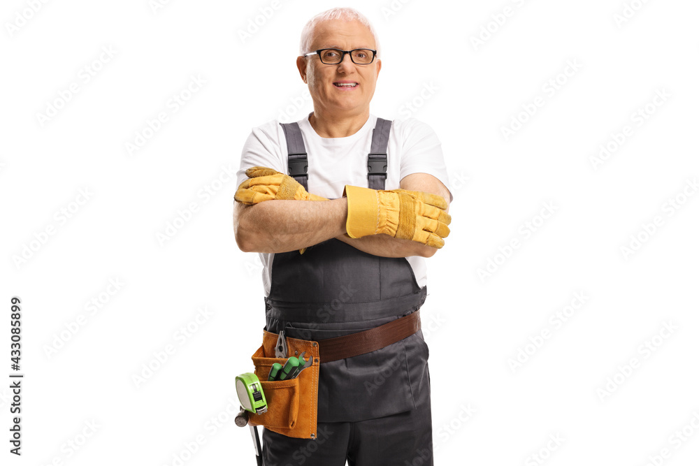 Repairman with a tool belt posing with crossed arms Repairman with a tool belt posing with crossed arms
