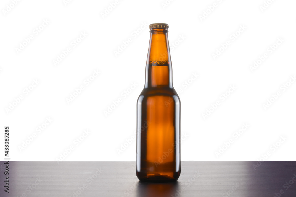 A brown beer bottle with no label isolated on white A brown beer bottle with no label isolated on white