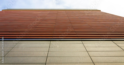 A fragment of a building wall with wooden slats.