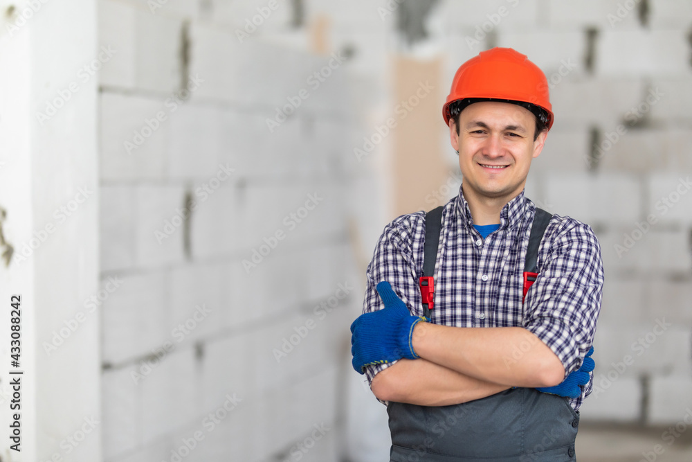 Happy male builder with crossed hands wearing white helmet Happy male builder with crossed hands wearing white helmet