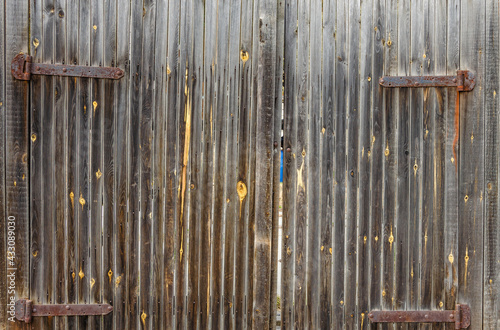 Old wooden gates made of vertical boards.