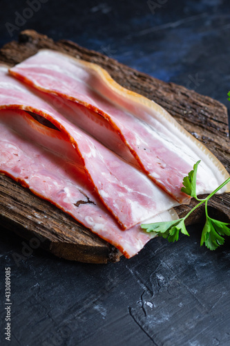 fresh bacon thin strip slice fatty meat and lard piece on the table healthy food meal snack copy space food background rustic. top view