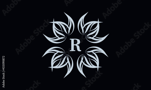 Vintage exquisite floral monogram with the letter R as a sign of business, boutique, shop, cafe, hotel, etc. Gray sign on a dark background