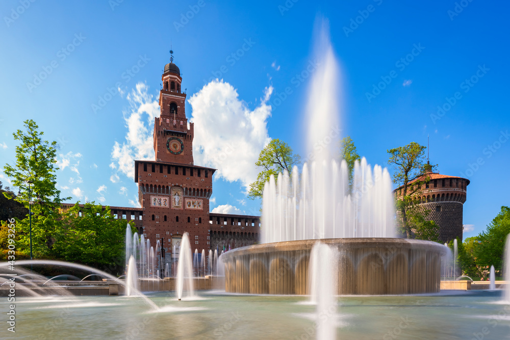 Main entrance to the Sforza Castle - Sforzesco castle and fountain in front of it,long exposure photo, sunny day and clouds in the sky,Milan, Italy