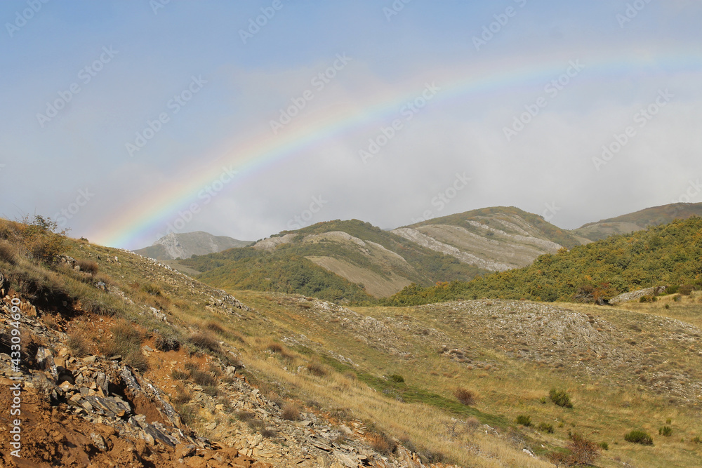 The rainbow over the Cantabrian mountain range, near La Robla, Leon, Spain