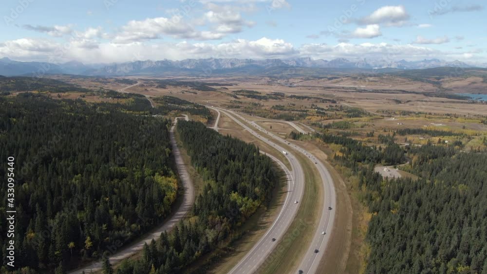 Aerial view of traffic on the Trans-Canada Highway between Calgary and Banff National Park during summer in Alberta, Canada. Aerial view of traffic on the Trans-Canada Highway between Calgary and Banff National Park during summer in Alberta, Canada.
