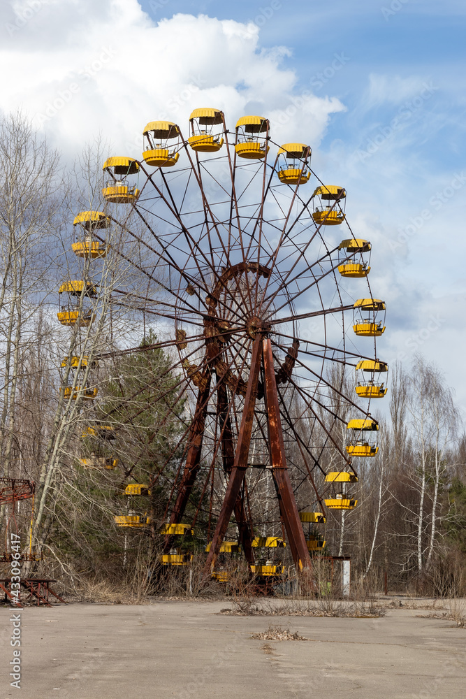 Old abandoned rusty metal radioactive yellow ferris wheel against dramatic sky in amusement park in ghost town Pripyat, Chernobyl Exclusion Zone Old abandoned rusty metal radioactive yellow ferris wheel against dramatic sky in amusement park in ghost town Pripyat, Chernobyl Exclusion Zone