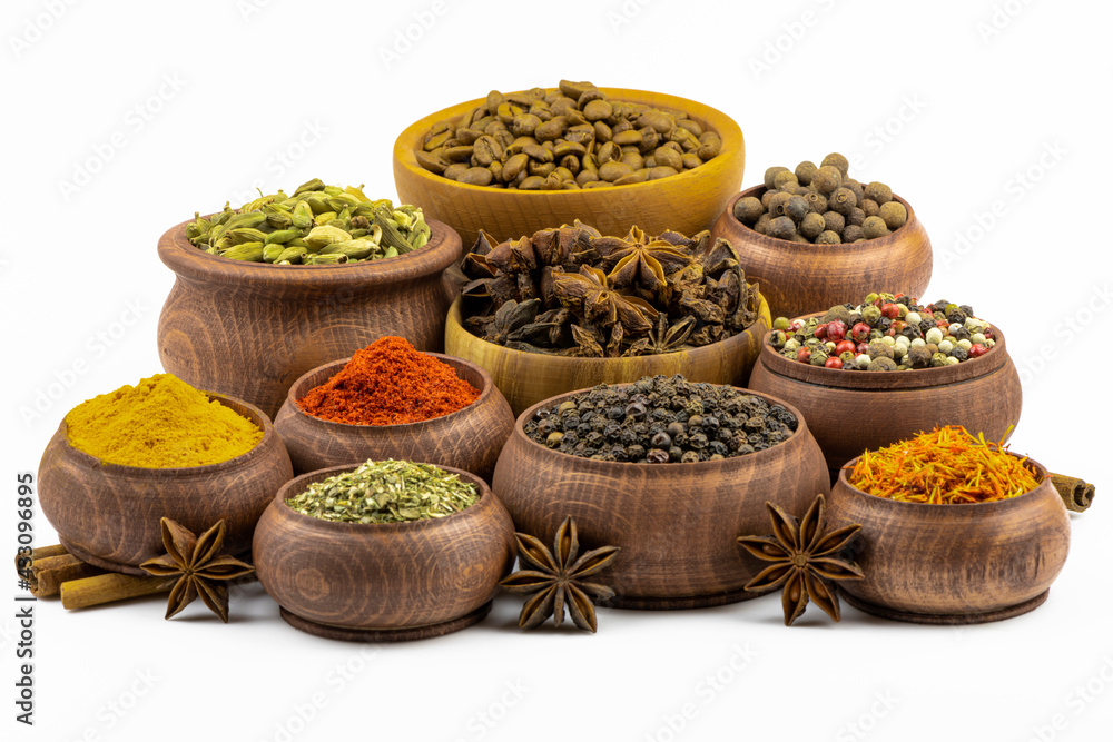An assortment of spices and seasonings isolated on a white background.