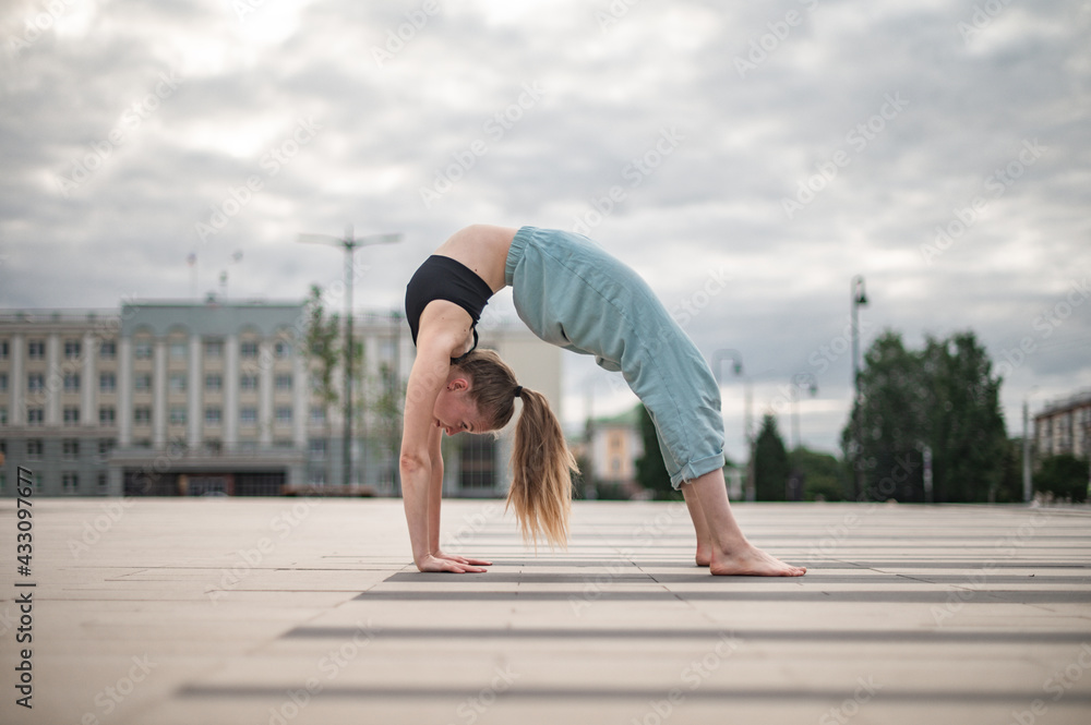 Girl practice yoga and meditation in the city. Girl practice yoga and meditation in the city.