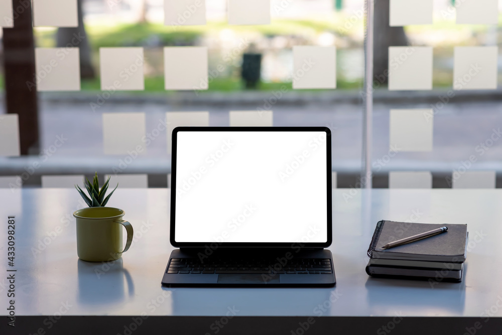 Front view tablet white screen placed at the table office. Mock up.