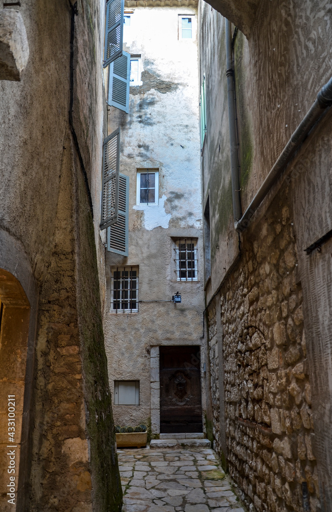 A narrow street with cobblestone road of charming old town Saint Paul de Vence in Provence, France.
