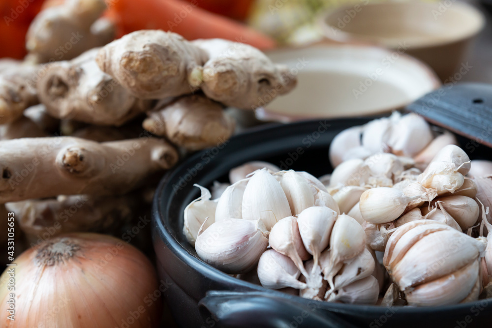 Fresh garlic in bowl, ginger and Vegetable in bowl for making kimchi. Mixed raw vegetables in traditional bowl used for cooking and making preserved food. Fresh garlic in bowl, ginger and Vegetable in bowl for making kimchi. Mixed raw vegetables in traditional bowl used for cooking and making preserved food.