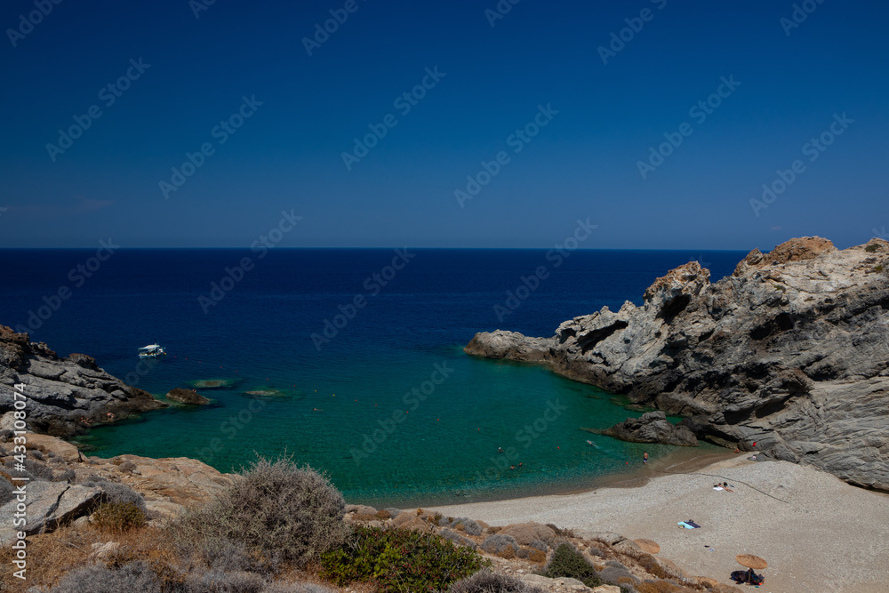 Paradise Nas beach with beautiful cove embedded by rugged rocks with azure blue water on the North Aegean island of Ikaria.