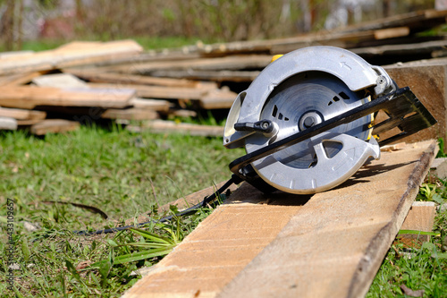 Circular hand electric saw  sawn boards  side view