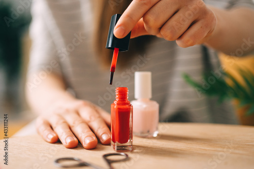 girl makes a red nail polish