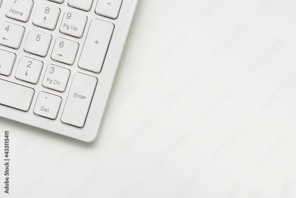 Computer keyboard, white desk, copy space, top view, cropped image Computer keyboard, white desk, copy space, top view, cropped image