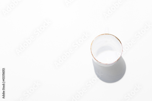 White ceramic empty cup with shadow, top view, flat lay, white background, copy space