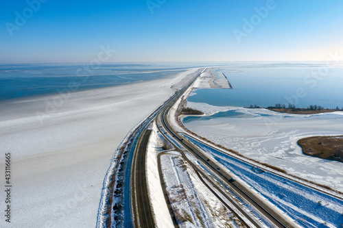 Fantastic beautiful drone photo of the dike from Enkhuizen to Lelystad. Photo taken with a drone on a beautiful sunny winter day.