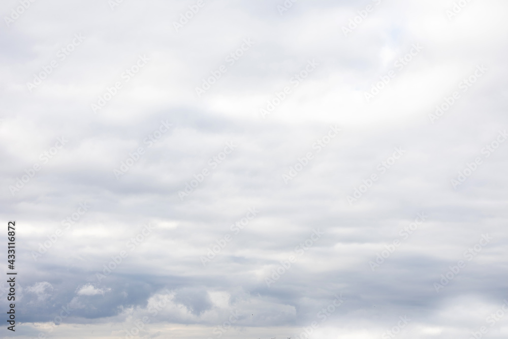Grey sky with fluffy clouds, abstract background